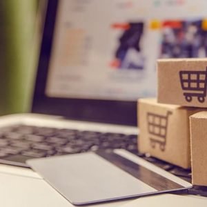 Shopping online concept - Shopping service on The online web. with payment by credit card and offers home delivery. parcel or Paper cartons with a shopping cart logo on a laptop keyboard